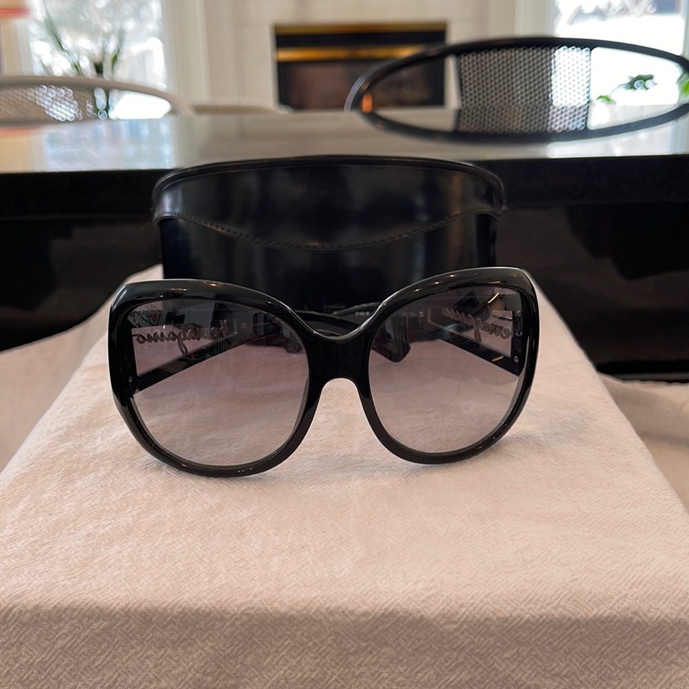 Ferragamo sun glasses black with designer name on side in silver